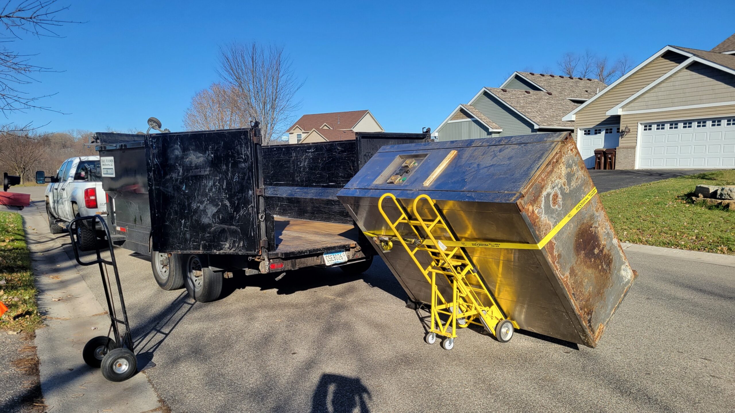 House Clean Out Services. A large junk oven in front of dump trailer. Location is in Minnesota