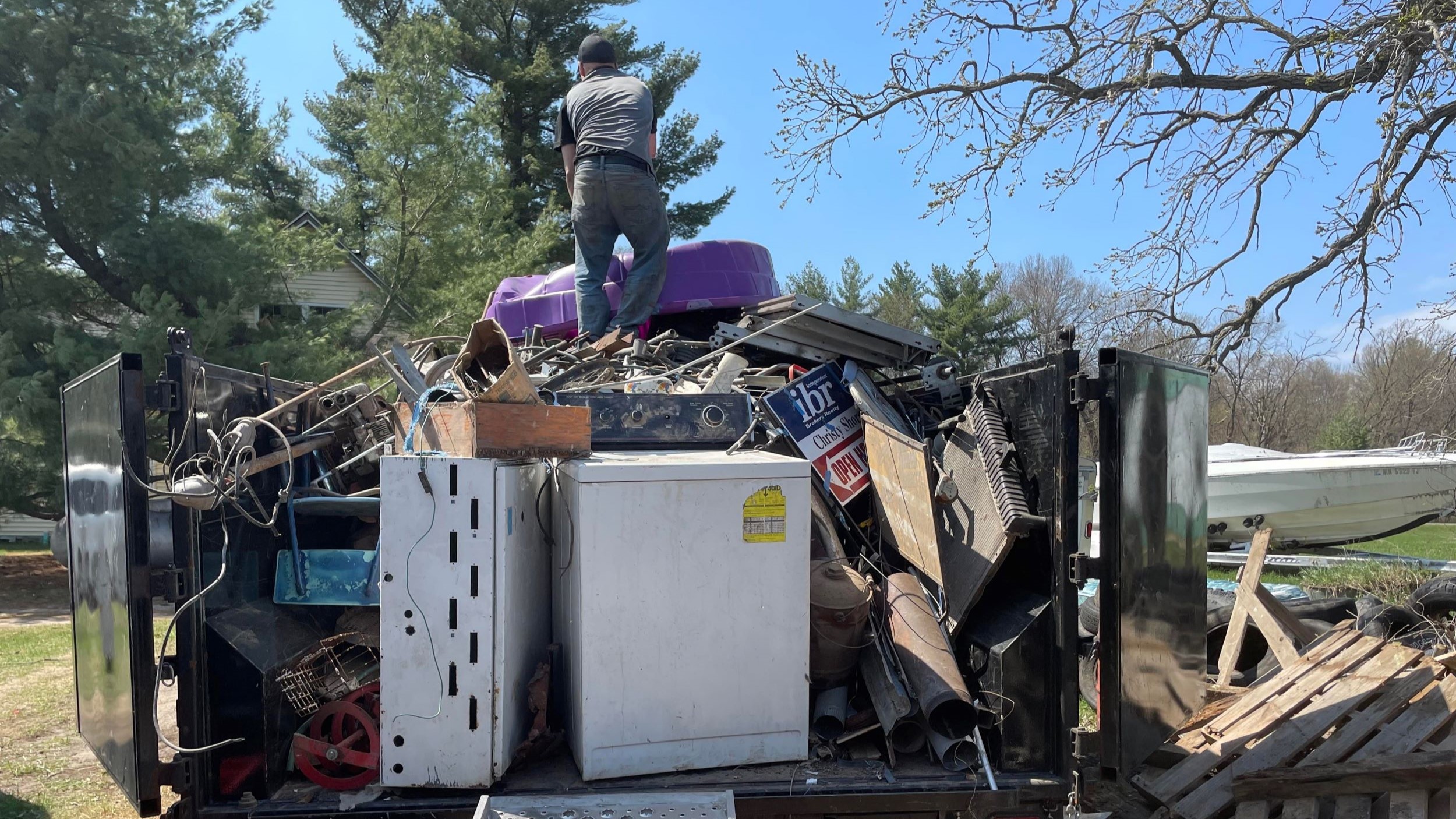 House clean outs. Piles of junk items and debris in dump trailer. Services in Minnesota.